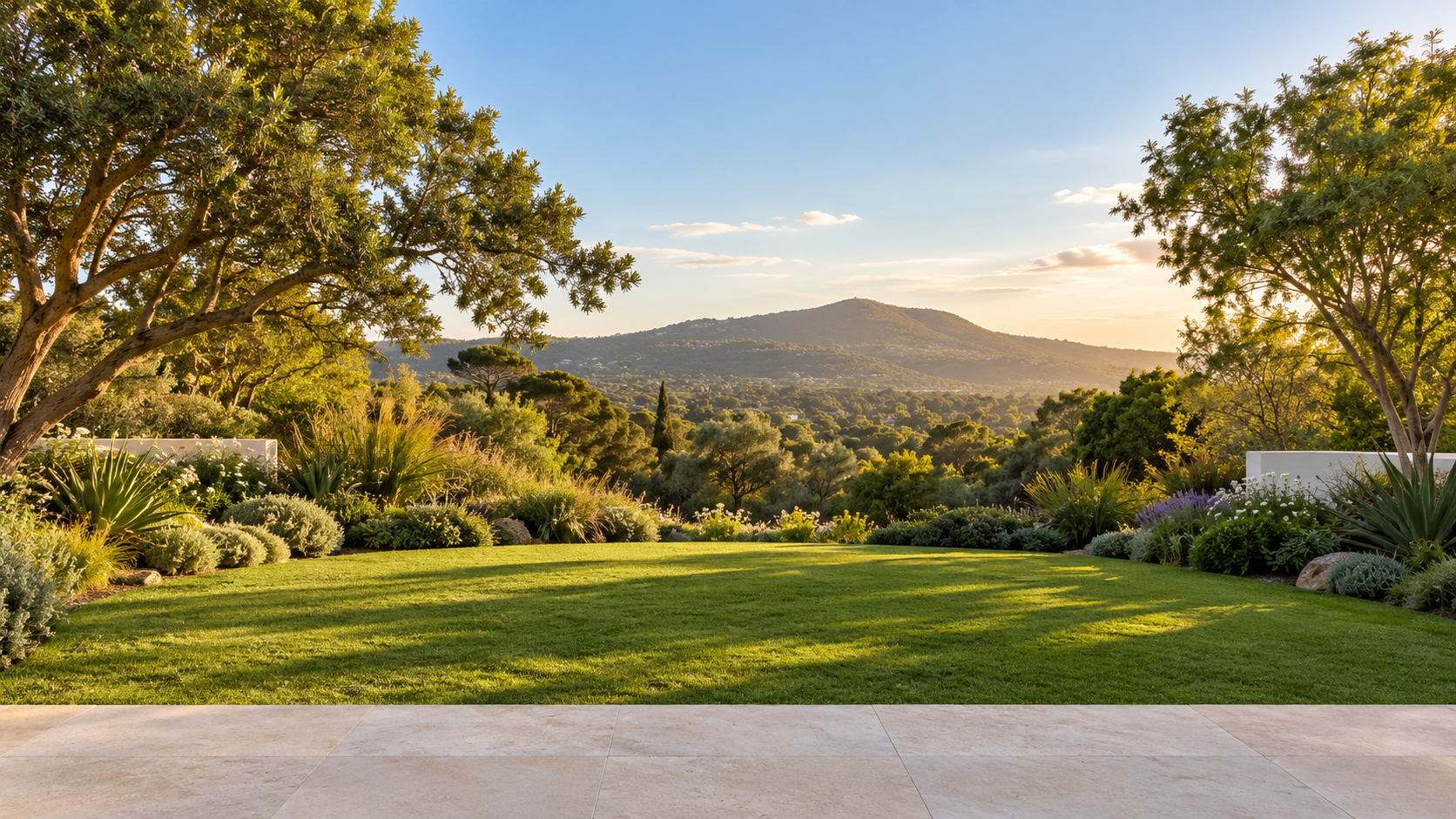 Sunlit garden and a distant green hillside beyond the interactive glass frame